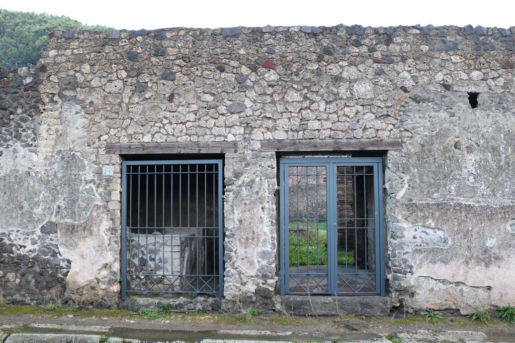 II.8.3 Pompeii, on left. December 2018. 
Looking east on Via di Nocera towards entrance doorways, with II.8.2, on right. Photo courtesy of Aude Durand.
