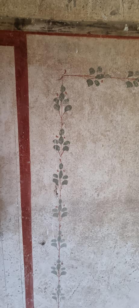 II.9.3, Pompeii. December 2023.
Room 14, detail from painted decoration from panel on north wall. 
Photo courtesy of Miriam Colomer.
