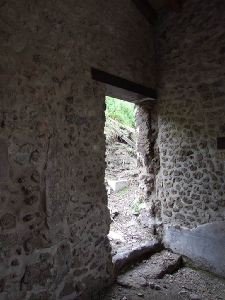 III.2.1 Pompeii.  March 2009.  Side entrance door, into unexcavated side road, from portico