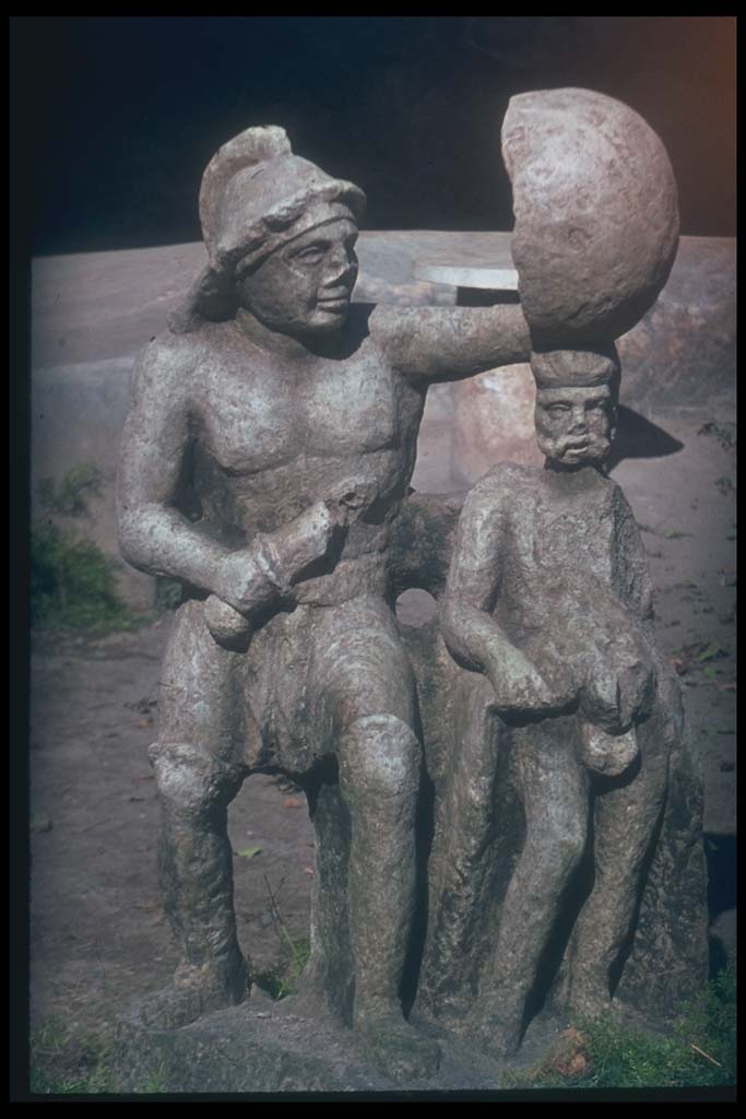 III.2.1 Pompeii. Statue of Gladiator, in peristyle garden as seen in the above photo.
Photographed 1970-79 by Günther Einhorn, picture courtesy of his son Ralf Einhorn.
The above statue was originally found in I.20.1.
It is now to be seen in the Forum Granary store (VII.7.29). 
