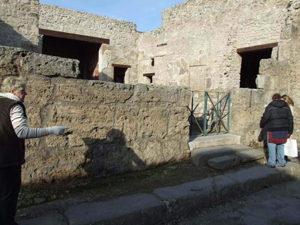 III.2.1 Pompeii. December 2007. Front wall on west side of entrance on Via dell’Abbondanza.
The wall on this side of the entrance was destroyed when a bomb landed in the atrium on 19th September 1943.
All of the painted graffiti, electoral recommendations and an announcement of games in the amphitheatre were lost.
The wall on the east side was devastated by another bomb landing to the south-east of the house in the Via dell’Abbondanza.
A small portion of the writings on the east side were saved, restored and can still be read today. 
See Garcia y Garcia, L., 2006. Danni di guerra a Pompei. Rome: L’Erma di Bretschneider. (p.51-53, incl. photos of damage).

