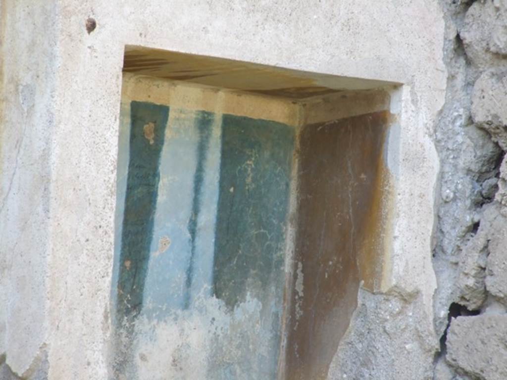 III.4.1 Pompeii. March 2009.  Yellow and blue walls inside the niche.
According to Boyce, it had an aedicula façade painted on the wall around it. 
Two pilasters supported a white architrave and a blue pediment which was ornamented with a white disc in the centre and surrounded by white cornices.  
The side walls within the niche were yellow, the back wall was blue, and the edges white.
See Boyce G. K., 1937. Corpus of the Lararia of Pompeii. Rome: MAAR 14.  (p.30, No.65, Pl.1, 6)
