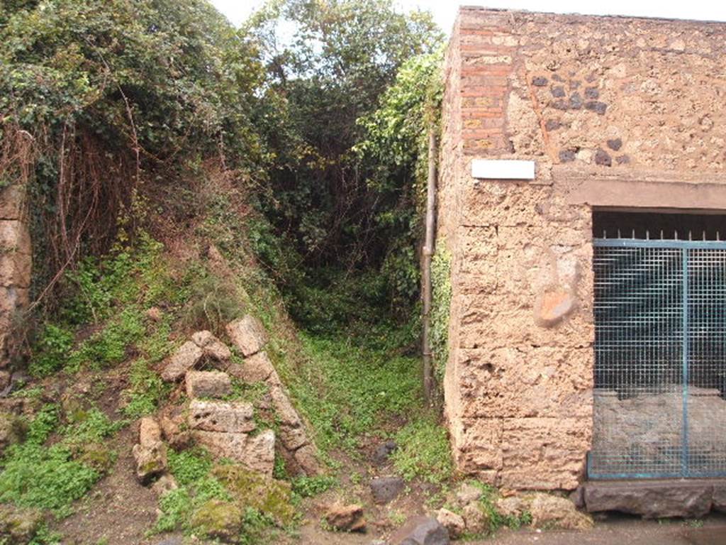 III.5 Pompeii. December 2004. Unexcavated roadway looking north.                  III.6.1  According to CTP, this insula was badly damaged during the aerial bombing of 1943, and this greatly damaged the inscriptions on the south and west wall. Two bombs fell on the roadway in the photo above, one landed at this junction with the Via dell’Abbondanza, the other landed slightly to the north. From the explosion of the nearest bomb, the above was seriously damaged and today retains very little of the character of its pre-war days. See Van der Poel, H. B., 1986. Corpus Topographicum Pompeianum, Part IIIA. Austin: University of Texas. (p.64)
According to Garcia y Garcia, because of the bombing all the decoration and the numerous inscriptions to the left and right of the entrance, on the south and west walls were lost.
See Garcia y Garcia, L., 2006. Danni di guerra a Pompei. Rome: L’Erma di Bretschneider. (p.60)




