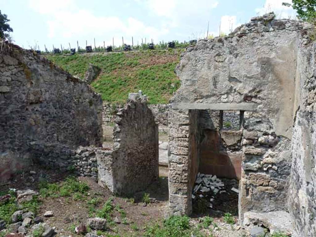 III.8.4 Pompeii. May 2010. Looking north across atrium, towards blocked doorway to III.8.3, entrance corridor, and small room.
