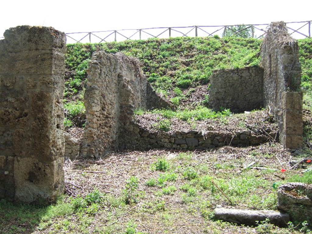 III.11.1 Pompeii. May 2006.  Looking south across Caupona. III.11.a (side entrance, one edge remains of the doorway in the west wall, on the right).

