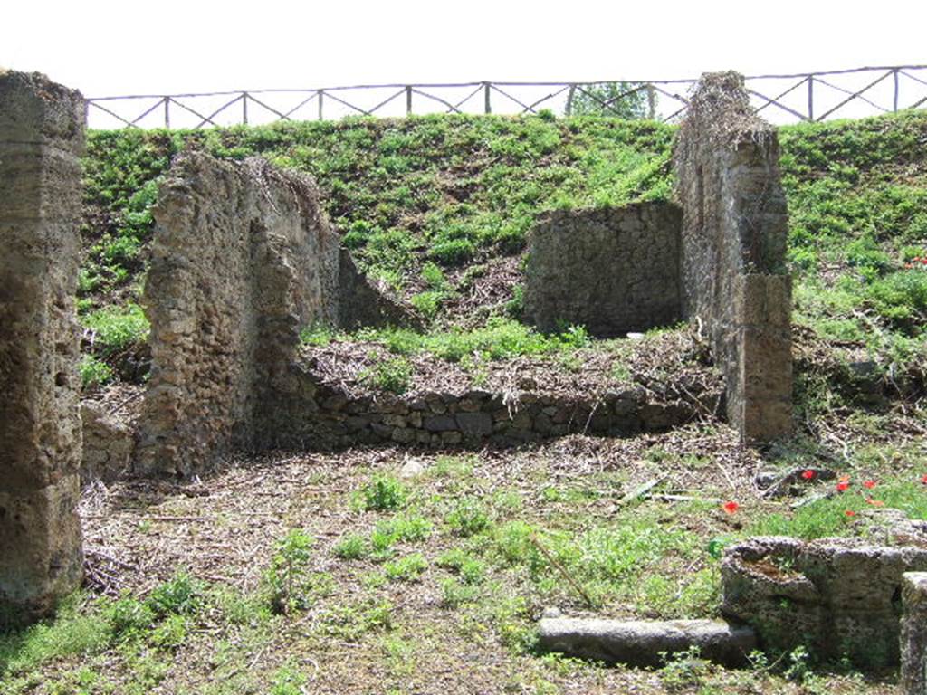 III.11.1 Pompeii. May 2006. Looking south across Caupona with III.11.a (side entrance, one edge remains of the doorway in the west wall).