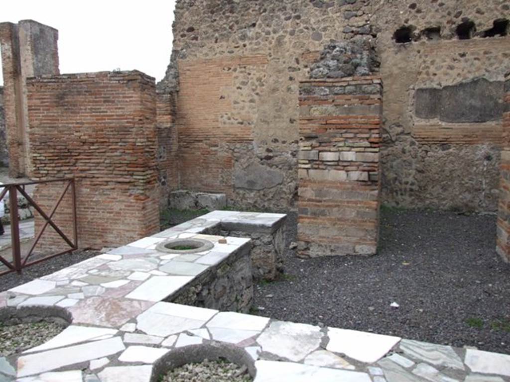 V.1.1 Pompeii. December 2007. Looking north to rear rooms with the entrance doorway at V.1.32, on the left.