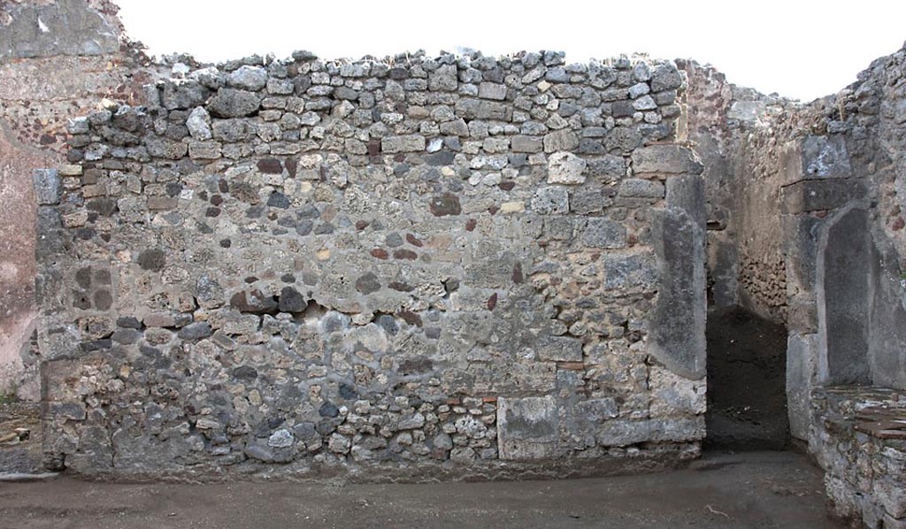 V.1.3 Pompeii. c.2008-10.  
Room 2, east wall of atrium, with doorway to corridor 3, (now blocked), in south-east corner. Photo by Hans Thorwid.
Photo courtesy of the Swedish Pompeii Project. 
