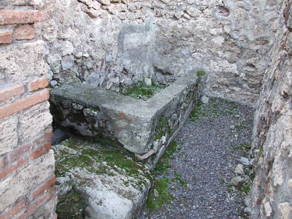 V.1.4 Pompeii.  December 2006. Looking north.  North west corner of rear room on west side, with base of stairs to upper floor and water basin.
