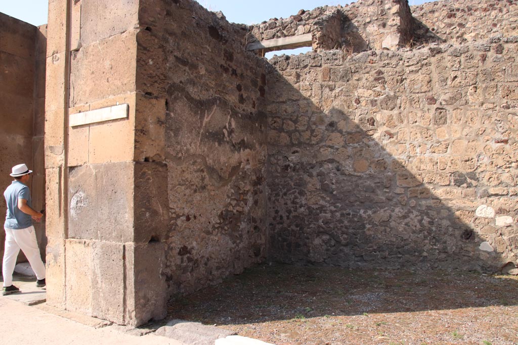 V.1.8 Pompeii. October 2023. West wall and north-west corner of shop-room. Photo courtesy of Klaus Heese.