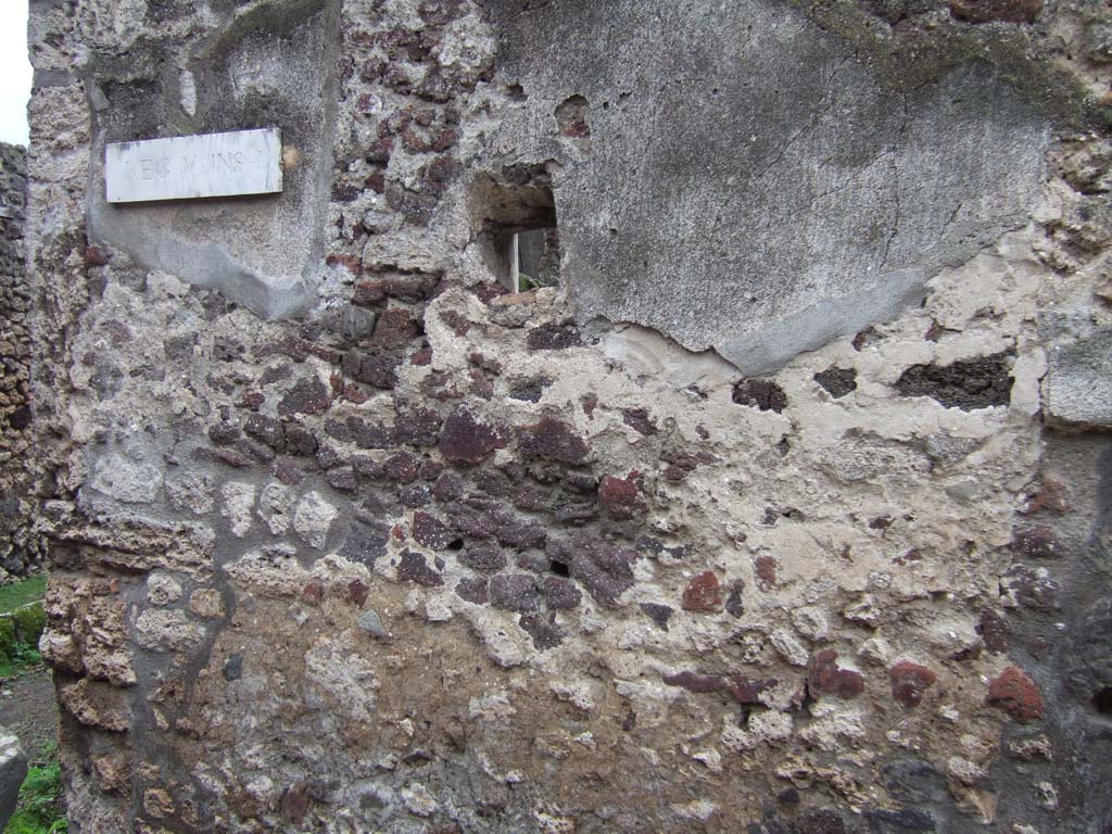 V.1.11 Pompeii. December 2005. East side of entrance doorway, on north-east corner of insula. Looking south.