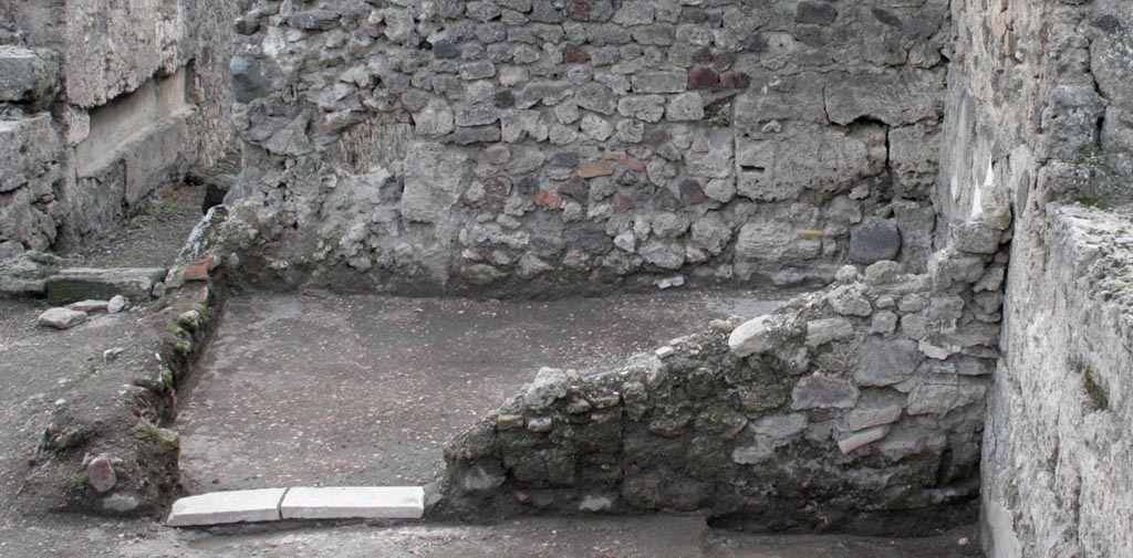 V.1.13 Pompeii. 2005. West wall of rear room “d”, before reconstruction, with doorway into room “e”. Photo by Hans Thorwid. 
“Room “e” is the only room in the caupona with high quality decorations. A cocciopesto floor with a circular mosaic pattern in the centre, has undecorated areas for clinae along the N and W walls. A marble threshold with two pivot holes is preserved in the doorway. A highly placed window, with recently restored window frame, opens to Vicolo delle Nozze d’Argento.”
Photo and words courtesy of the Swedish Pompeii Project.
