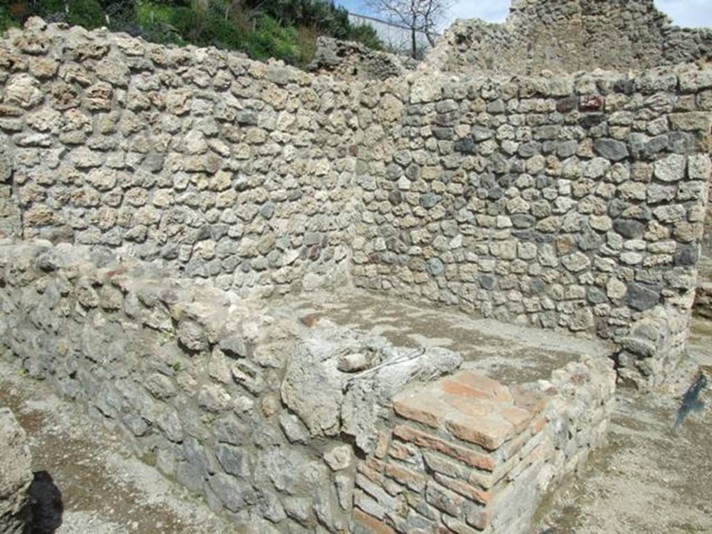 V.1.15 Pompeii. April 2009. Looking north-east towards room in bakery on north side.
According to CTP in 1986,  “This pistrinum was severely damaged by bombs during the bombing of September 1943. The whole north-east portion was destroyed. One bomb partially broke up the roadway in front of the street entrance. This has now been restored in part, whereas the four rooms to the north-east and part of the north perimetral wall have not yet been restored.”
See Van der Poel, H. B., 1986. Corpus Topographicum Pompeianum, Part IIIA. Austin: University of Texas. (p.70)
