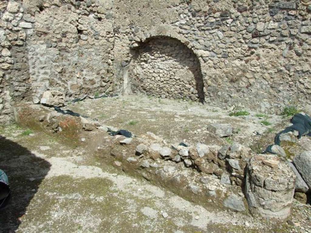 V.1.15 Pompeii. April 2009.  Small garden in north east corner, and remains of one of the columns for supporting the Portico. 