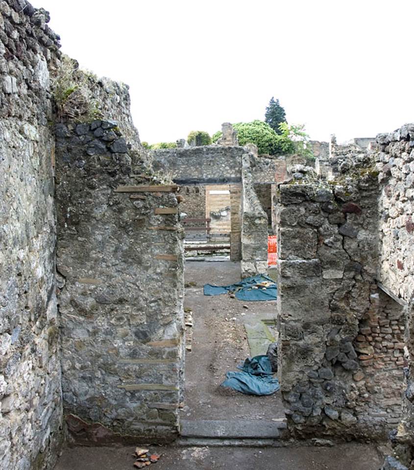 V.1.15 Pompeii. c.2012.  
“West wall of room “f”, with doorway into atrium. Photo by Hans Thorwid.
Photo courtesy of the Swedish Pompeii Project.
