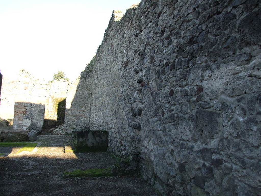 V.I.16 Pompeii. December 2006. Bakery shop, looking towards south wall of shop and atrium of V.1.15 to rear.   