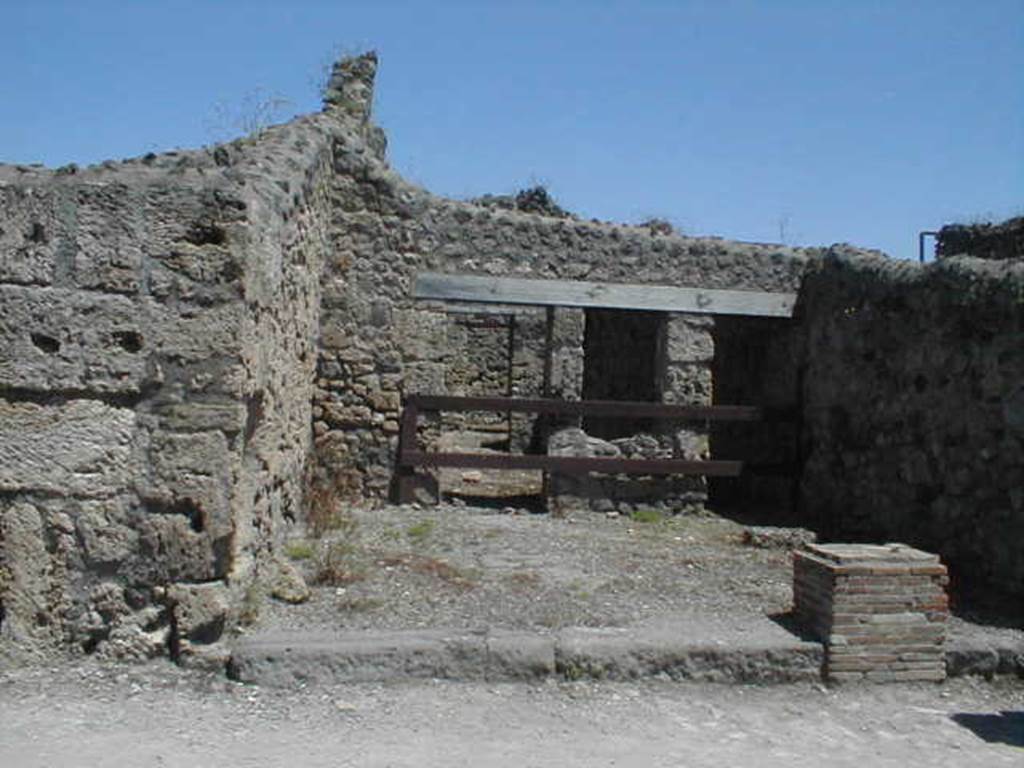 V.1.20 Pompeii. May 2005. Looking east across shop to dwelling at rear.