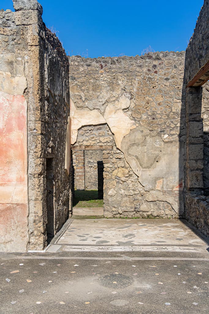 V.1.26 Pompeii. October 2023. 
Room “e”, north ala, looking towards north wall with passageway to V.1.23 at west end. 
Photo courtesy of Johannes Eber.

