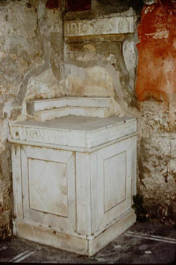 V.I.26 Pompeii. 1957. Room b, marble lararium in north-west corner of atrium.  Photo by Stanley A. Jashemski.
Source: The Wilhelmina and Stanley A. Jashemski archive in the University of Maryland Library, Special Collections (See collection page) and made available under the Creative Commons Attribution-Non Commercial License v.4. See Licence and use details.
J57f0414
