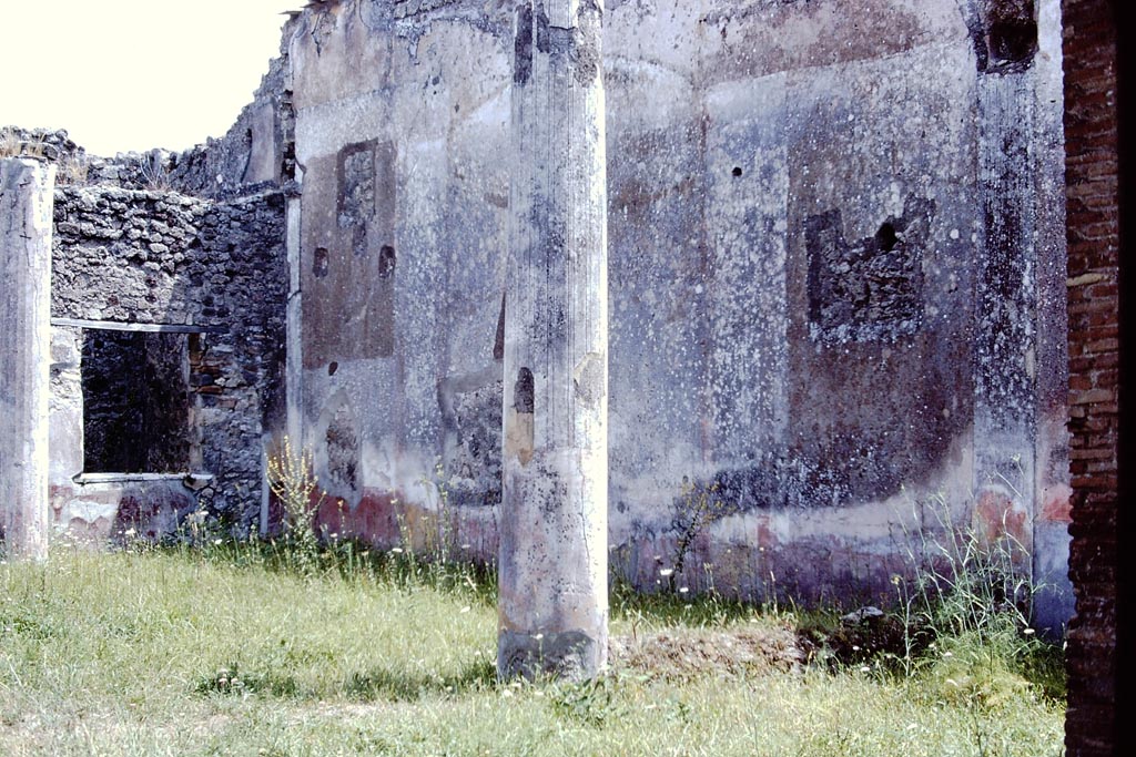 V.1.26 Pompeii. 1972. Room l, peristyle garden, looking towards south-east corner with window to room t.
The south wall of the garden would have contained a painted hunt scene in the arched centre panel, and a garden scene on either side.
Photo by Stanley A. Jashemski. 
Source: The Wilhelmina and Stanley A. Jashemski archive in the University of Maryland Library, Special Collections (See collection page) and made available under the Creative Commons Attribution-Non-Commercial License v.4. See Licence and use details.
J72f0404

