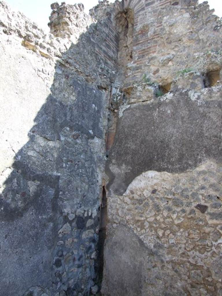 V.1.30 Pompeii. March 2009. Rear room, south-east corner. Waste pipe from upper floor niche latrine.
