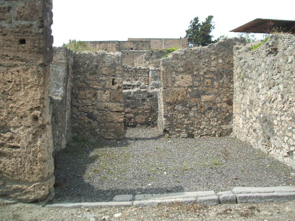 V.2.6 Pompeii. May 2005. Looking north across shop towards rear room.