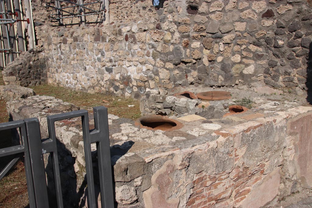 V.2.19 Pompeii. October 2022. . Looking north-east across counter in bar-room. Photo courtesy of Klaus Heese.