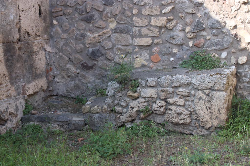 V.3.3 Pompeii. October 2023. Base of steps against north wall in north-west corner of shop-room. Photo courtesy of Klaus Heese.