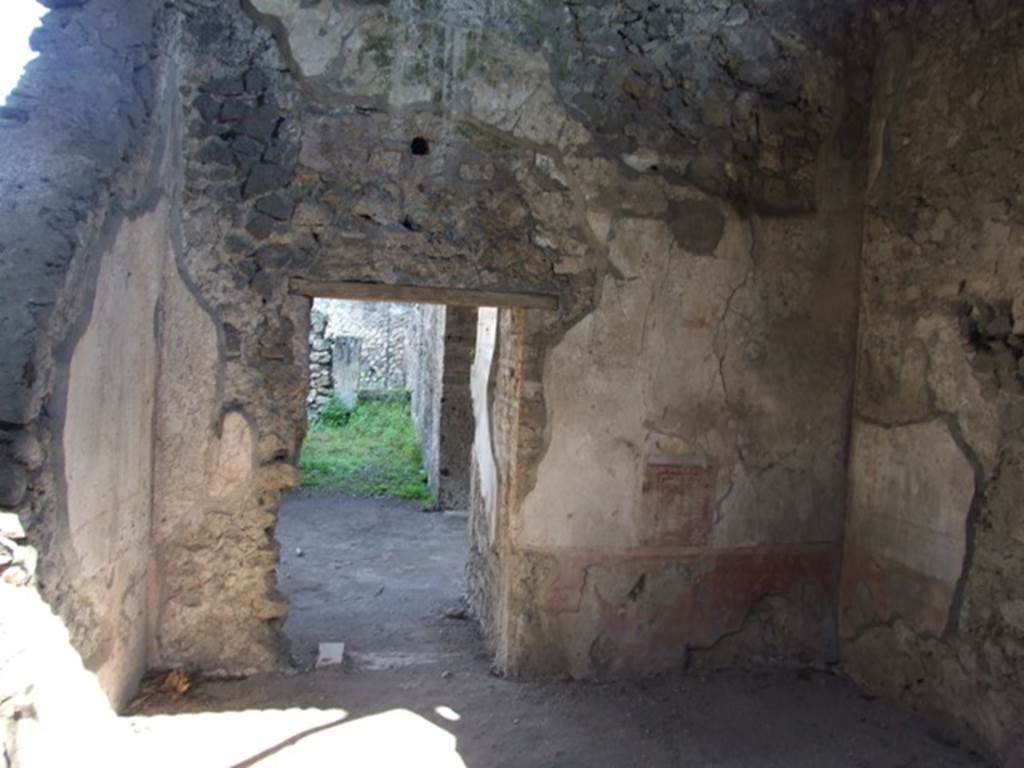 V.3.4 Pompeii. March 2009. Triclinium, east wall, with door to anteroom. According to Sogliano, found on the east wall in the area between the cornice and the vault, on a white background, were arabesques, in the centre of which was a flying golden eagle. See Notizie degli Scavi di Antichità, 1905,  (p.213).
