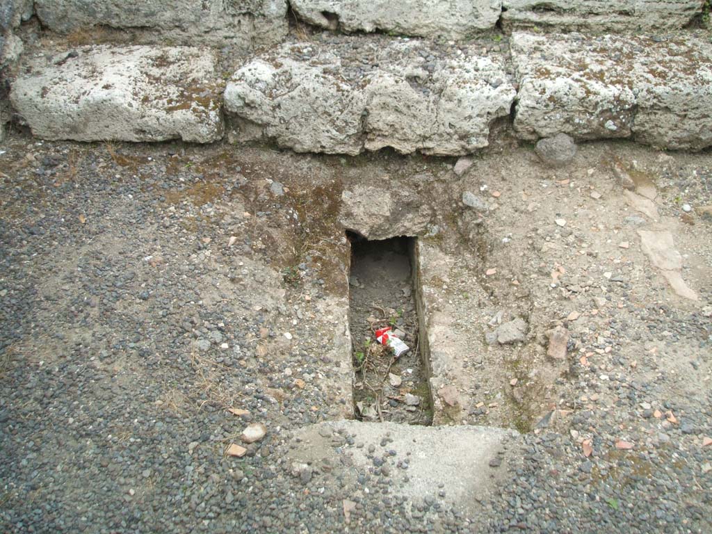 V.3.4 Pompeii, May 2005. Channel in floor in vestibule, on south side of steps.