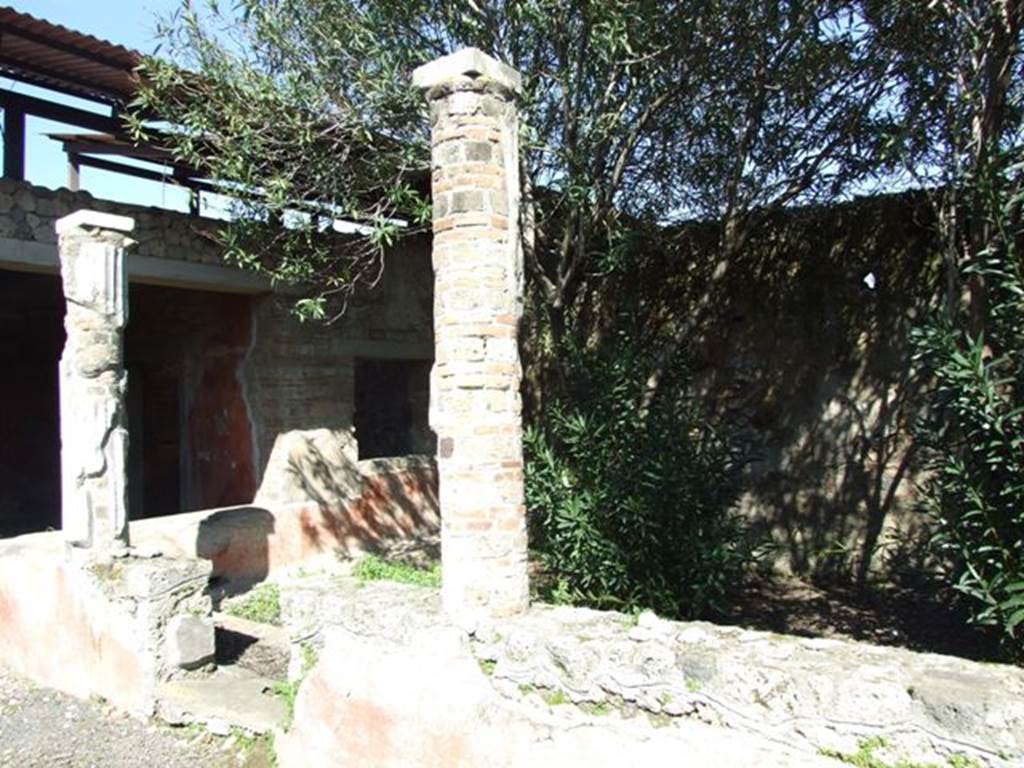 V.3.4 Pompeii. March 2009. Small garden area.  Two white stuccoed columns on west side of garden, which supported the west and partial north portico.
