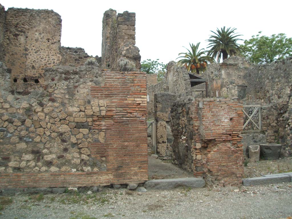 V.4.1 Pompeii. May 2005. Entrance on Via di Nola.
This doorway led to a bakery linked with a dwelling, of which the front half had already been excavated up until 1890.
Thus, from the material used, mainly predominated by limestone (Sarno stone), this house dated back to a rather ancient time, and only in later times would have been used as a bakery, as seen by the remains of decoration of the second style in the upper floor, 

The doorway, once fitted with a door, led into the long and narrow entrance corridor/fauces “A”, with brick floor, in which to the right were the doorways leading into the shop at V.4.2 and with the stable “B” lit up by three windows, two overlooking into the shop and the third into the corridor; and to the left opened the entrance to a second stable “C”, linked with a third “D”. Certainly, we will not be surprised by the presence of these three stables, if one thinks of the use of animals of burden, which a bakery would have needed.

