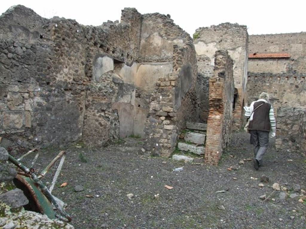 V.4.1 Pompeii. December 2007. Looking north at west side of atrium.
In the west wall, on the left, would have been a walled-up doorway, leading into Vicolo di M L Frontone.



