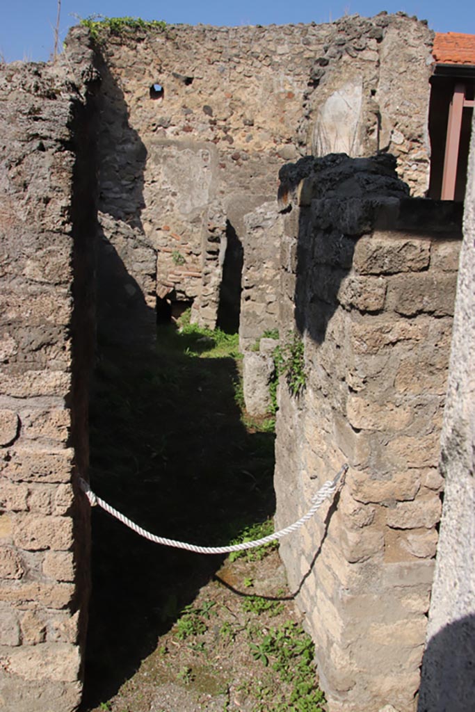 V.4.a Pompeii. October 2023. 
Room ‘p’, looking north through doorway, towards north wall with doorway to kitchen area.
Photo courtesy of Klaus Heese.
