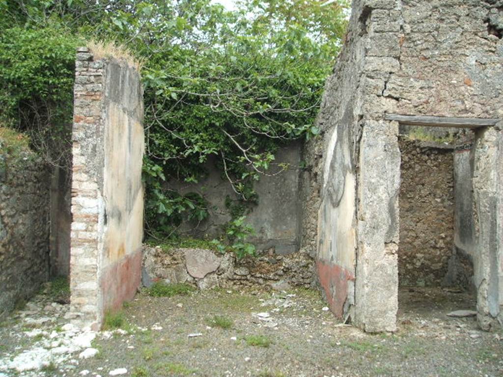 V.4.c Pompeii. May 2005. Room G, tablinum on east side of atrium B. At the rear of the tablinum is the low east wall with window to garden K behind. On the left is the doorway to corridor or andron J. Cubiculum H is on the right.