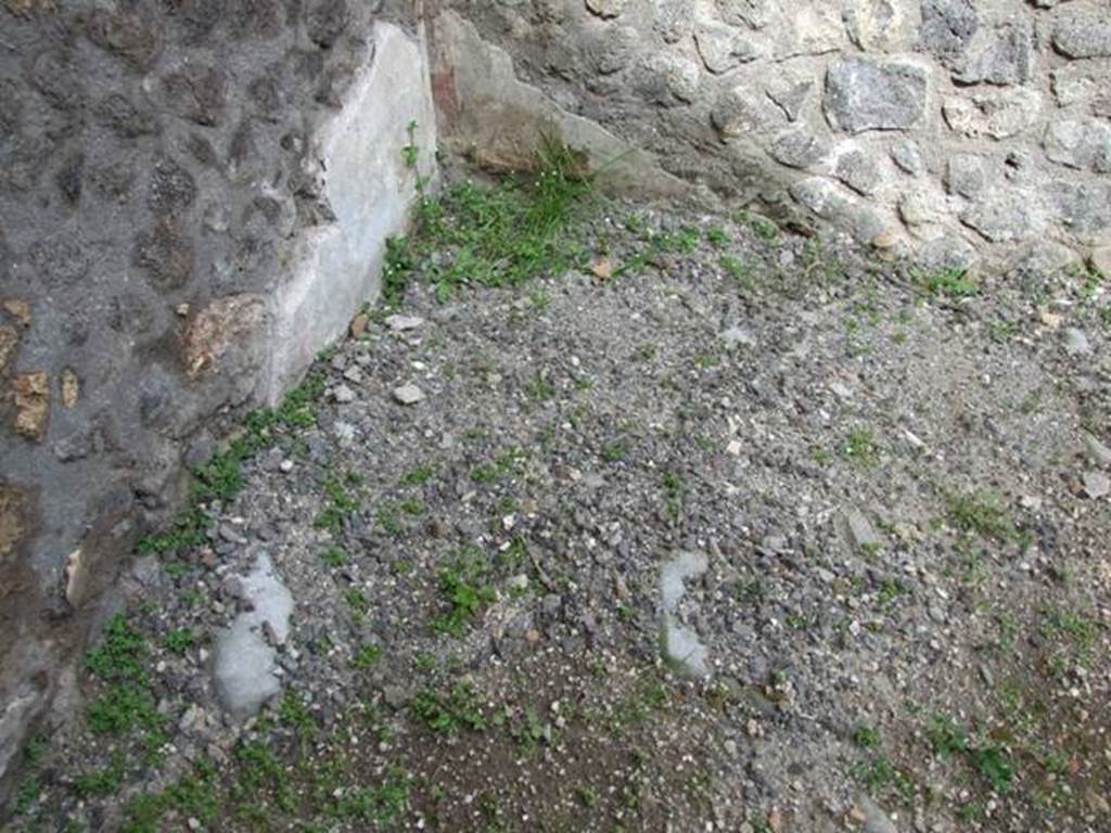 V.5.4 Pompeii. March 2009. Remains of plaster in north east corner of shop, which was the area of the stairs to the upper floor.