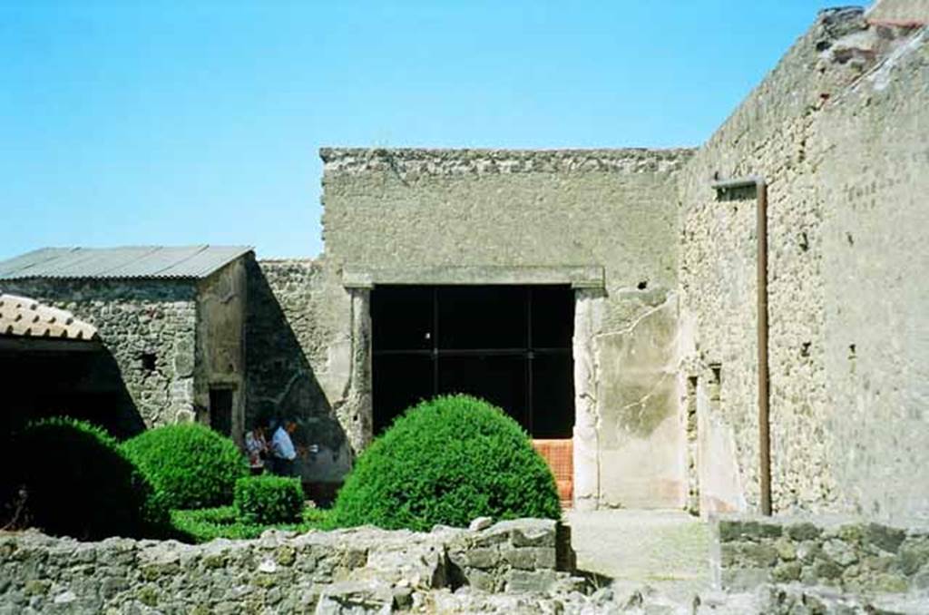 VI.2.4 Pompeii. June 2010. Looking west towards exedra of small garden apartment, from the kitchen area. Photo courtesy of Rick Bauer.