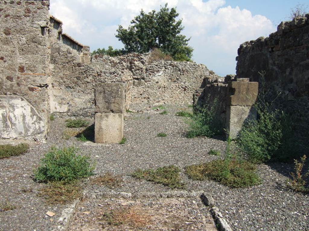 VI.2.12 Pompeii. September 2005. Room 2 atrium, looking east towards room 5, tablinum.
Room 6 is on the left and corridor 4 on the right of the tablinum.
