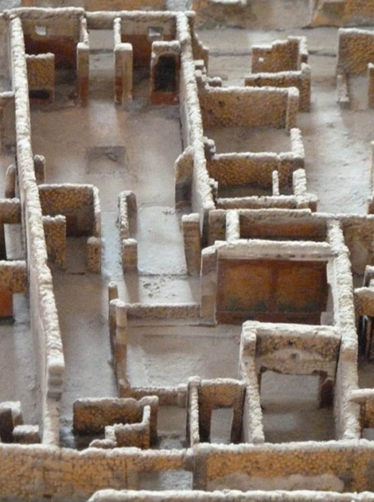 VI.2.15 Pompeii. May 2010. Looking east from rear entrance in Vicolo di Narciso. Model as viewed in Naples Archaeological Museum.
