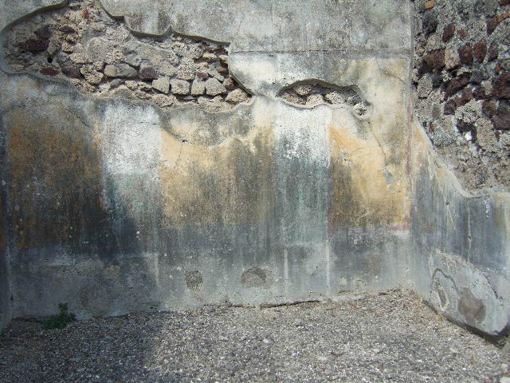 VI.2.16 Pompeii. September 2005. North wall of room on north side of peristyle. 
According to PPM 
The north wall was preserved up until the curve of the vaulted ceiling, which was marked by a cornice of stucco, now lost. 
The wall was painted in the IV Style in a scheme with a symmetrical structure, with (yellow?) zoccolo subdivided into panels and compartments, and a yellow middle zone, with panels separated by architecture. 
Probably in this room the vignettes of Cupids, as drawn by Zahn, were to be found, (Helbig 649 and 699b). 
The upper zone of the wall was white.
See Carratelli, G. P., 1990-2003. Pompei: Pitture e Mosaici. IV.  Roma: Istituto della enciclopedia italiana, p. 202.
See Zahn, W., 1828. Die schnsten Ornamente und merkwrdigsten Gemlde aus Pompeji, Herkulanum und Stabiae: I. Berlin: Reimer, taf. 74.
See Helbig, W., 1868. Wandgemlde der vom Vesuv verschtteten Stdte Campaniens. Leipzig: Breitkopf und Hrtel, (nos. 649 and 699b).
