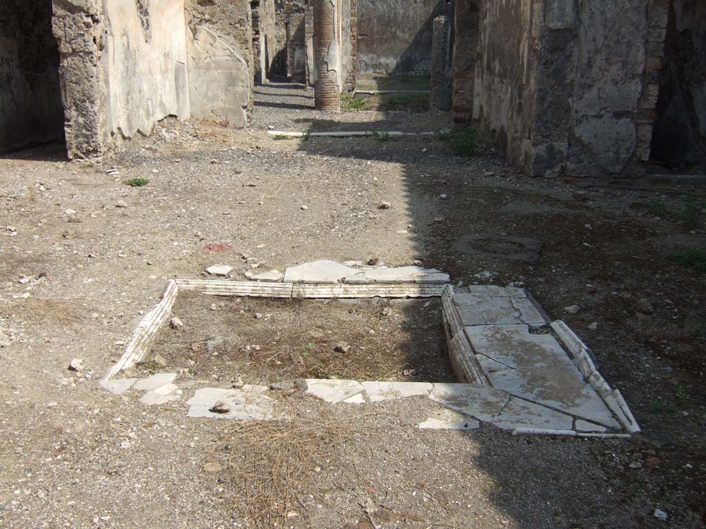 VI.2.16 Pompeii. September 2005. Looking east across marble impluvium in atrium towards tablinum and peristyle.