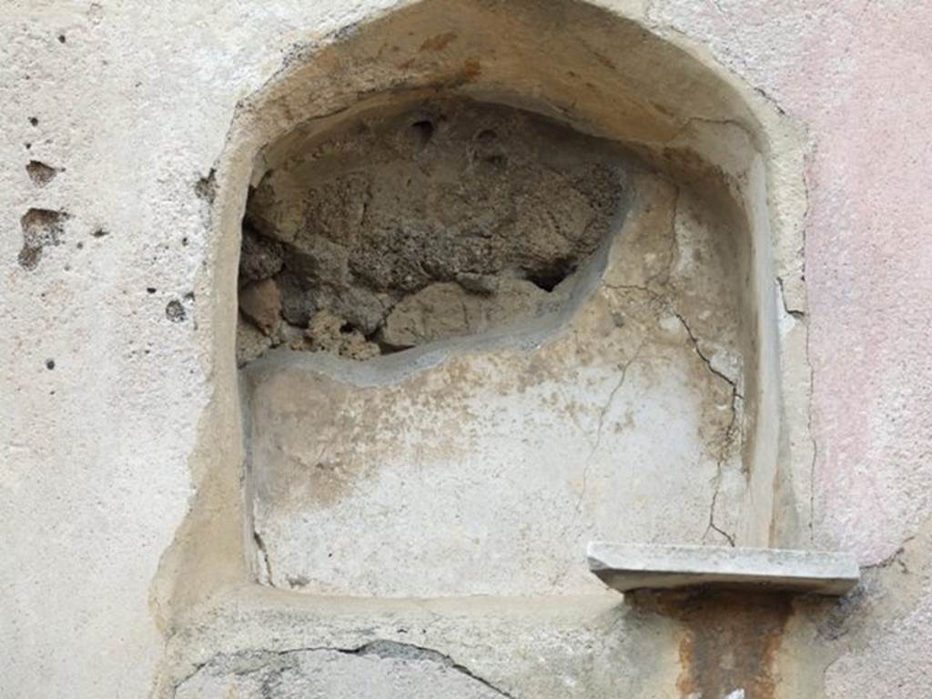 VI.2.24 Pompeii. December 2007. Arched niche in west wall of garden area, with remains of marble shelf. According to Giacobello, this is at quite a considerable height from the floor.  The internal walls of the niche were painted in white. The niche was visible from the vestibule at the entrance.
See Giacobello, F., 2008. Larari Pompeiani: Iconografia e culto dei Lari in ambito domestico.  Milano: LED Edizioni. (p.269)
