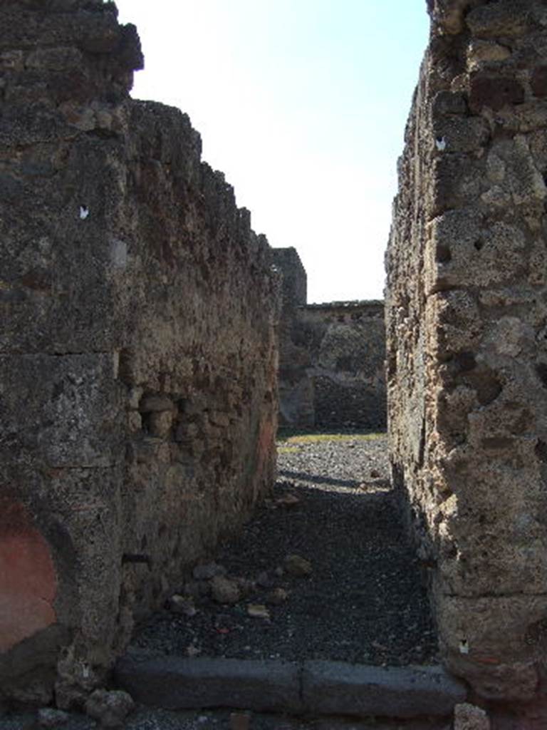 VI.2.25 Pompeii. September 2005. Looking west along long narrow entrance corridor leading directly into the peristyle garden.
