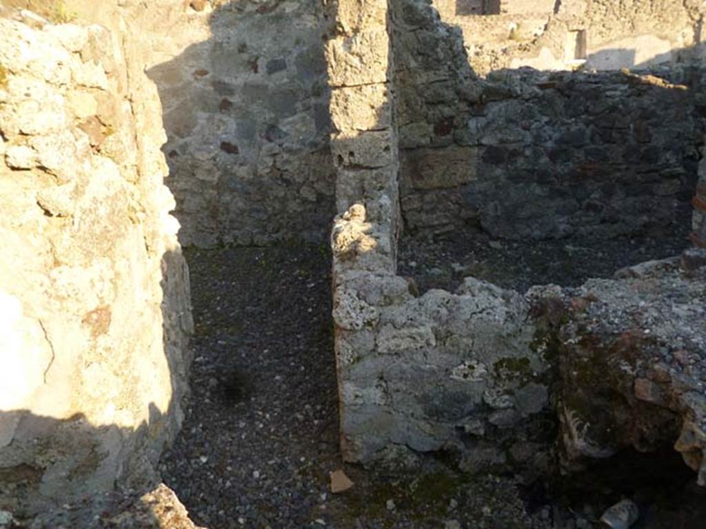 V1.2.27 Pompeii. May 2011. Looking south-east along corridor from kitchen area. In the upper right is a room of VI.2.28, probably a storeroom on east side of kitchen area belonging to that house.
