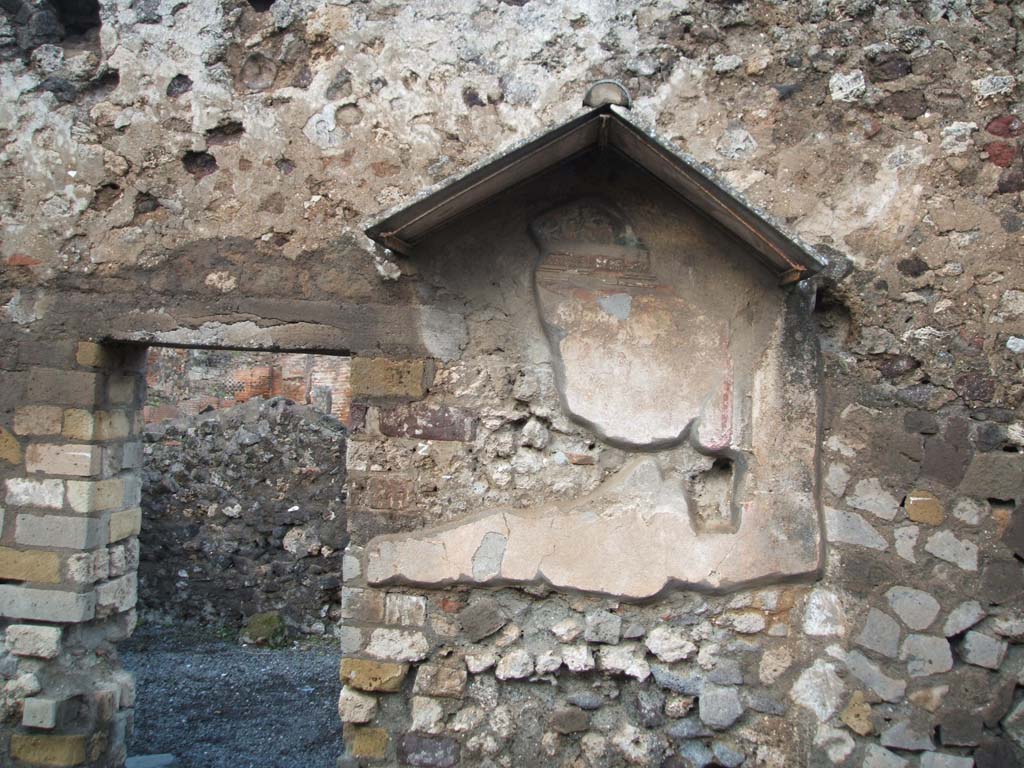 VI.4.4 Pompeii. December 2004. North wall, with remains of painted lararium shrine.
