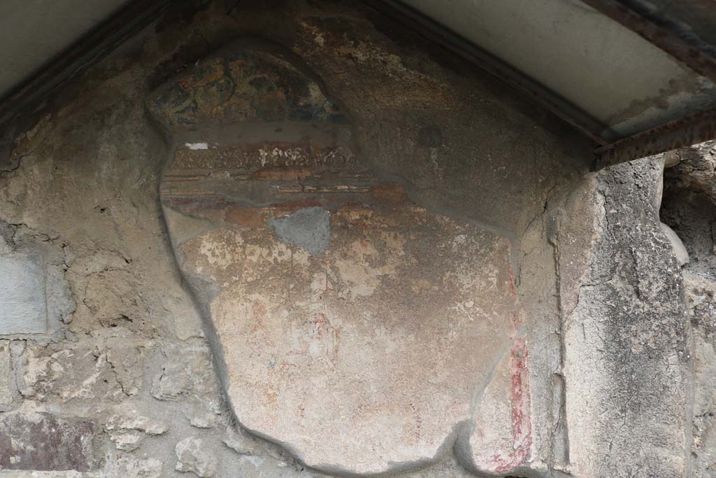 VI.4.4 Pompeii. December 2018. North wall, with remains of painted lararium shrine. Photo courtesy of Aude Durand.