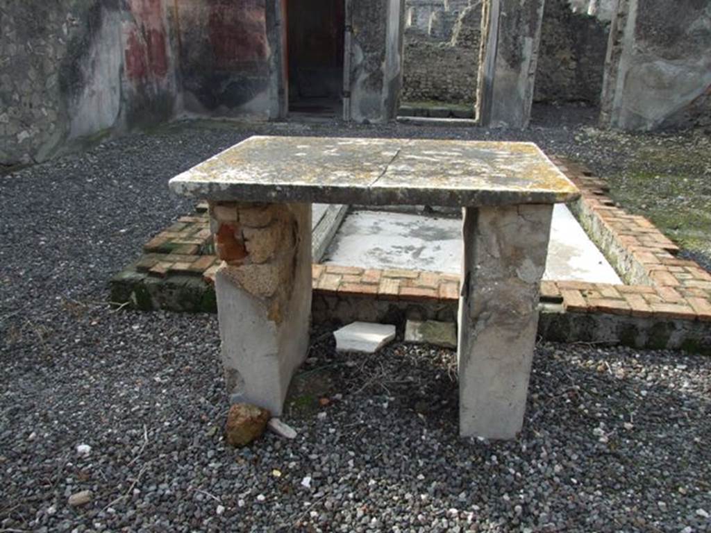 VI.5.3 Pompeii. December 2007. Marble top table and impluvium in atrium.  
Looking west across atrium towards entrance corridor.
