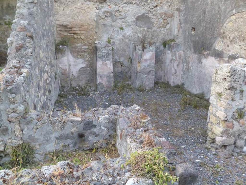 VI.5.3 Pompeii. May 2011. Looking north into doorway into room 13, in the north-east corner (one of the four rooms with other rooms above). Room 11 can be seen in the lower left of photograph.
