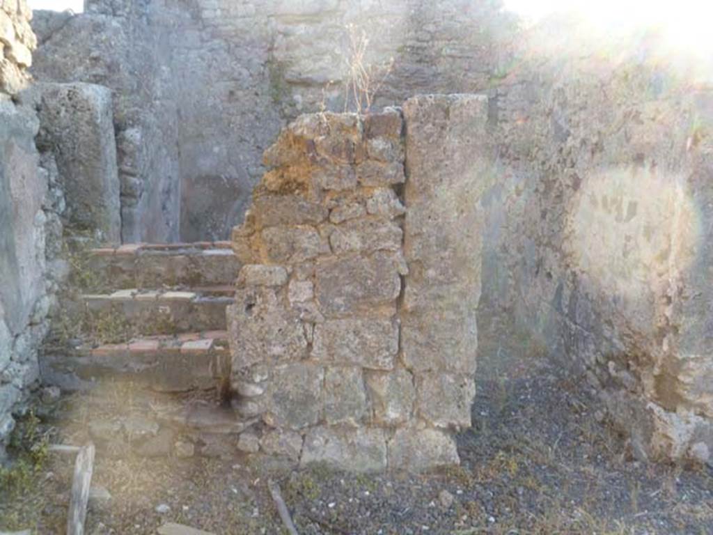 VI.5.9 Pompeii. May 2011.  Looking west from south-west corner of atrium, towards stairs to upper floor and doorway to cubiculum.
