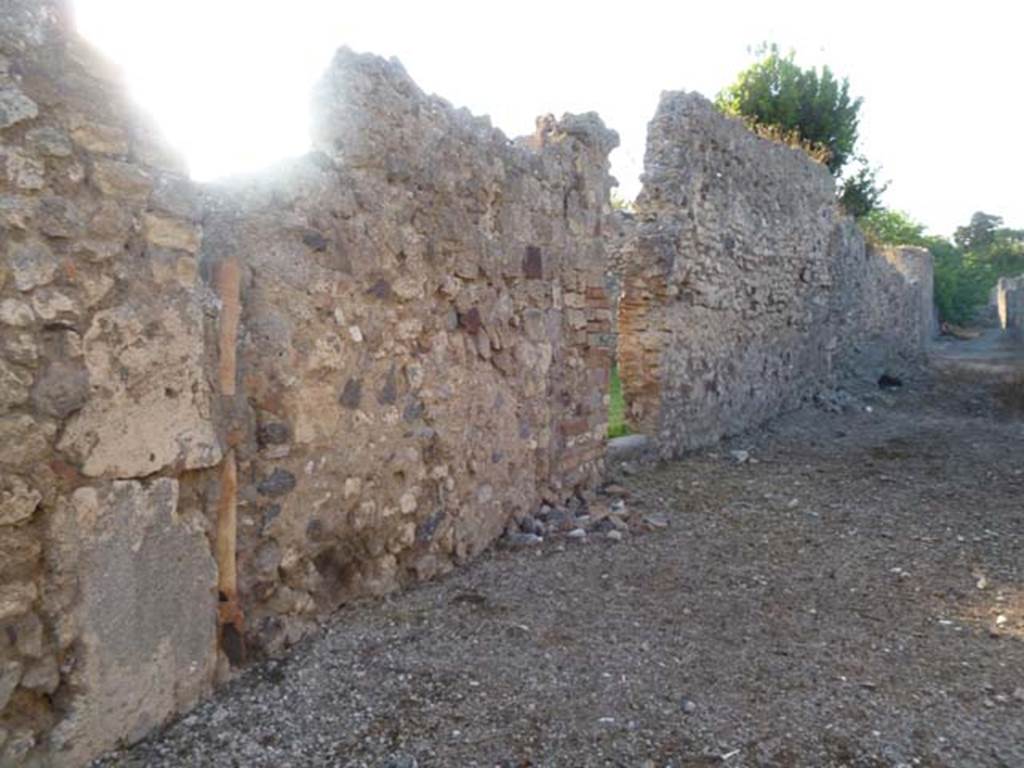 VI.5.20 Pompeii. May 2011. Looking north-west towards entrance doorway on west side of Vicolo della Fullonica. 